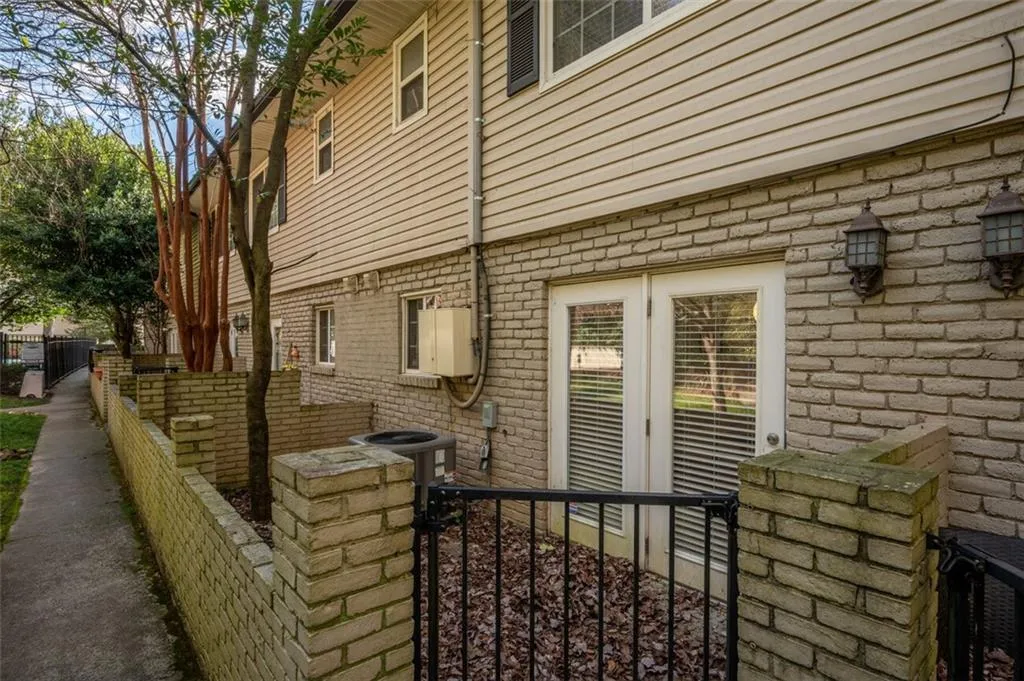 View of side of property with a central air condition unit and brick siding