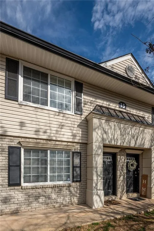 Doorway to property featuring brick siding