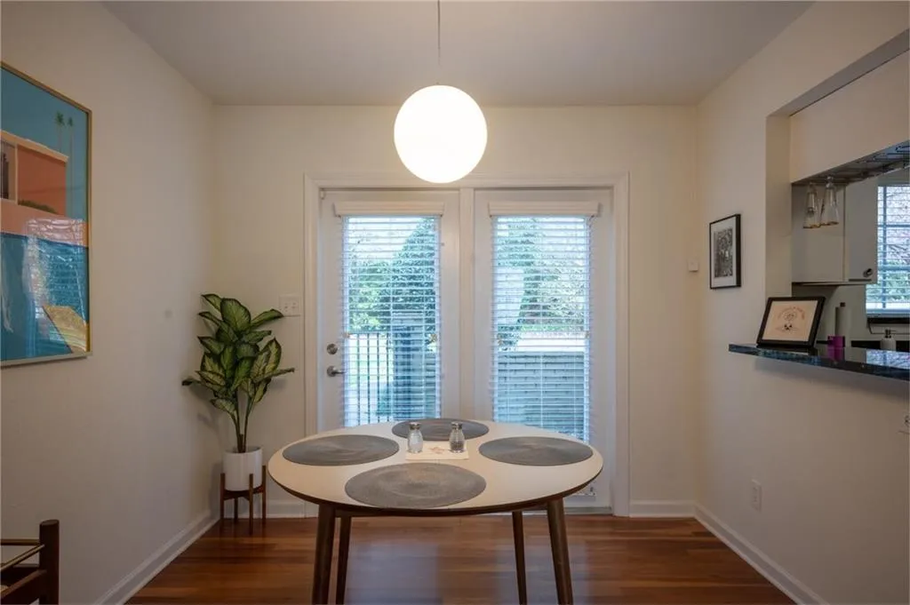 Dining room with dark wood-style floors and baseboards