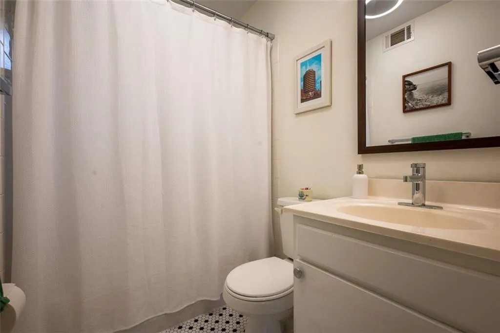 Full bath featuring vanity and a shower with shower curtain