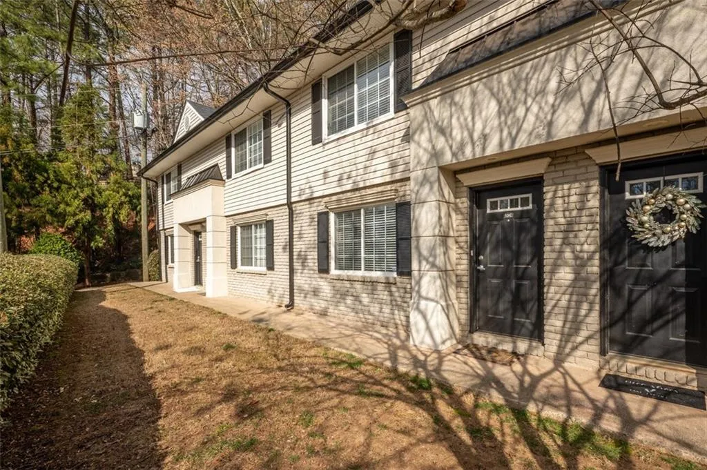 View of side of property featuring brick siding