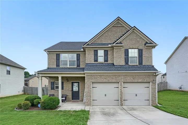 Two-story brick exterior with a two-car garage
