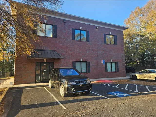 View of property with uncovered parking