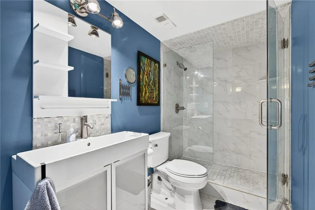 Updated bathroom with walk in glass shower.