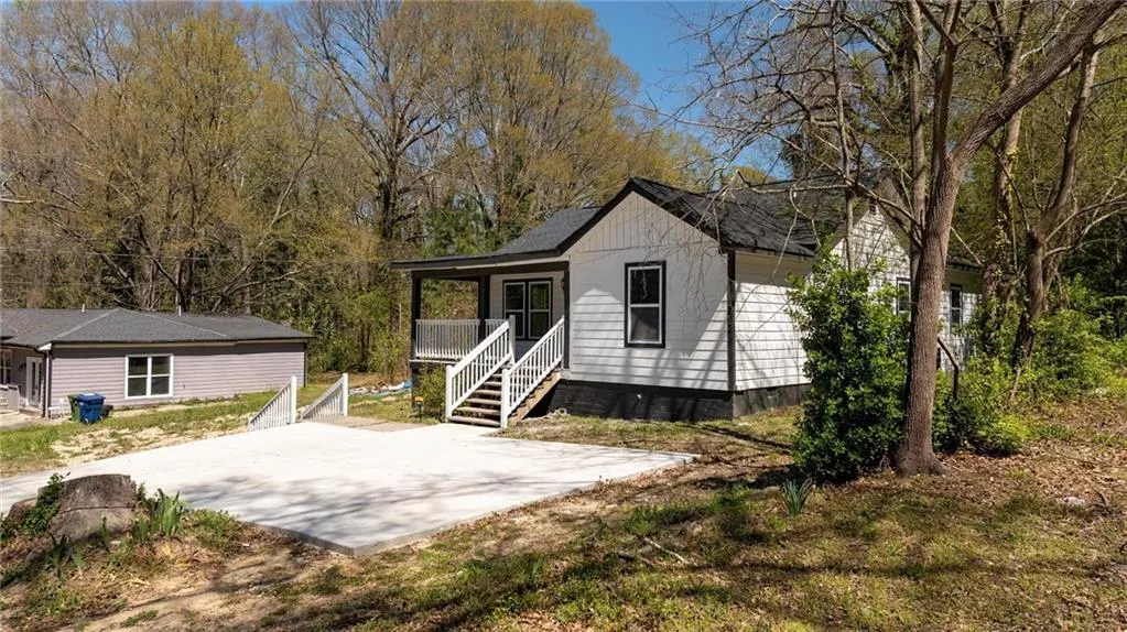 Rear view of house featuring covered porch