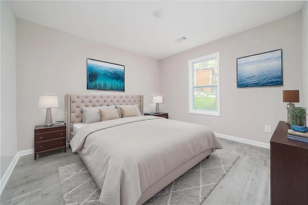 Bedroom with baseboards, visible vents, and light wood-type flooring