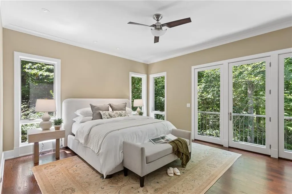 Hardwood flooring, crown molding, white trim, recessed lighting, and a ceiling fan with light fixture