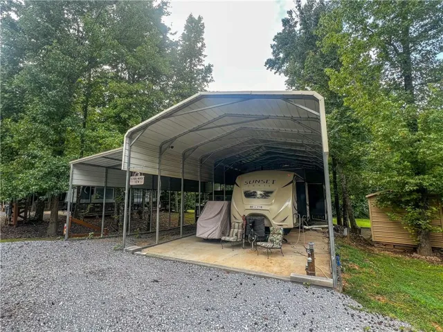 Large metal carport with an additional covered parking structure