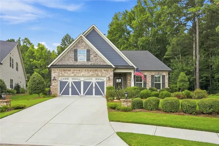 Stone and siding exterior with a gabled roofline