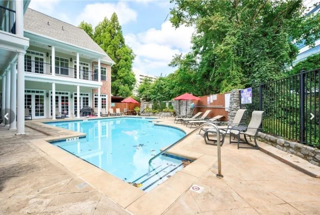 Community pool featuring fence, a patio, and french doors