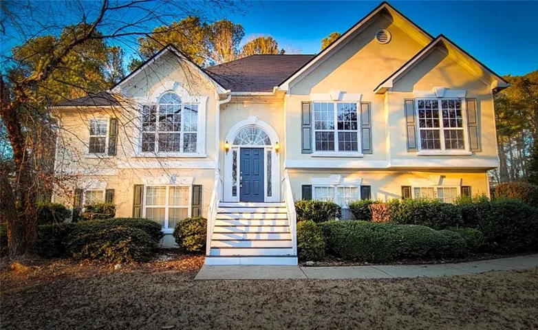 Traditional style residence featuring a prominent gabled roofline and light-colored siding
