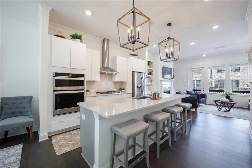 Kitchen with backsplash, ornamental molding, open floor plan, white cabinets, and dark wood-type flooring