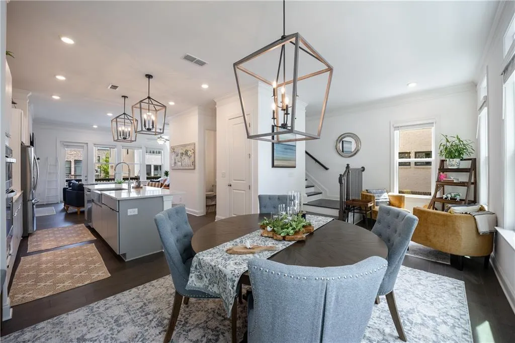 Dining space featuring stairs, ornamental molding, dark wood-style floors, a chandelier, and recessed lighting