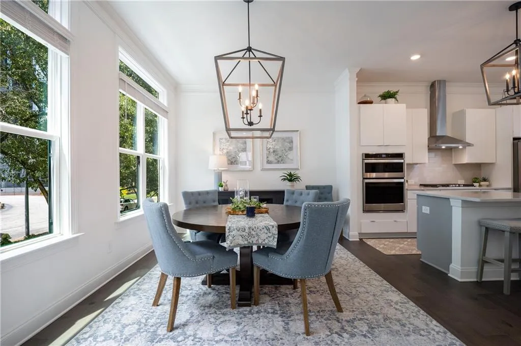 Dining area with a chandelier, dark wood-style floors, crown molding, and recessed lighting