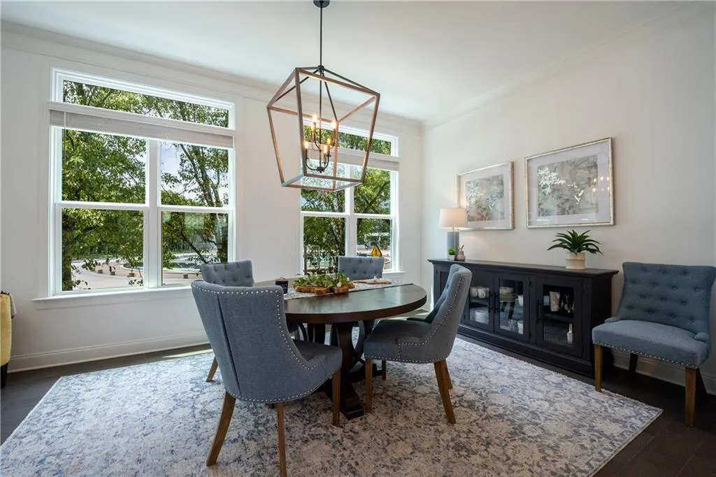 Dining area with ornamental molding, dark wood-style floors, and a chandelier
