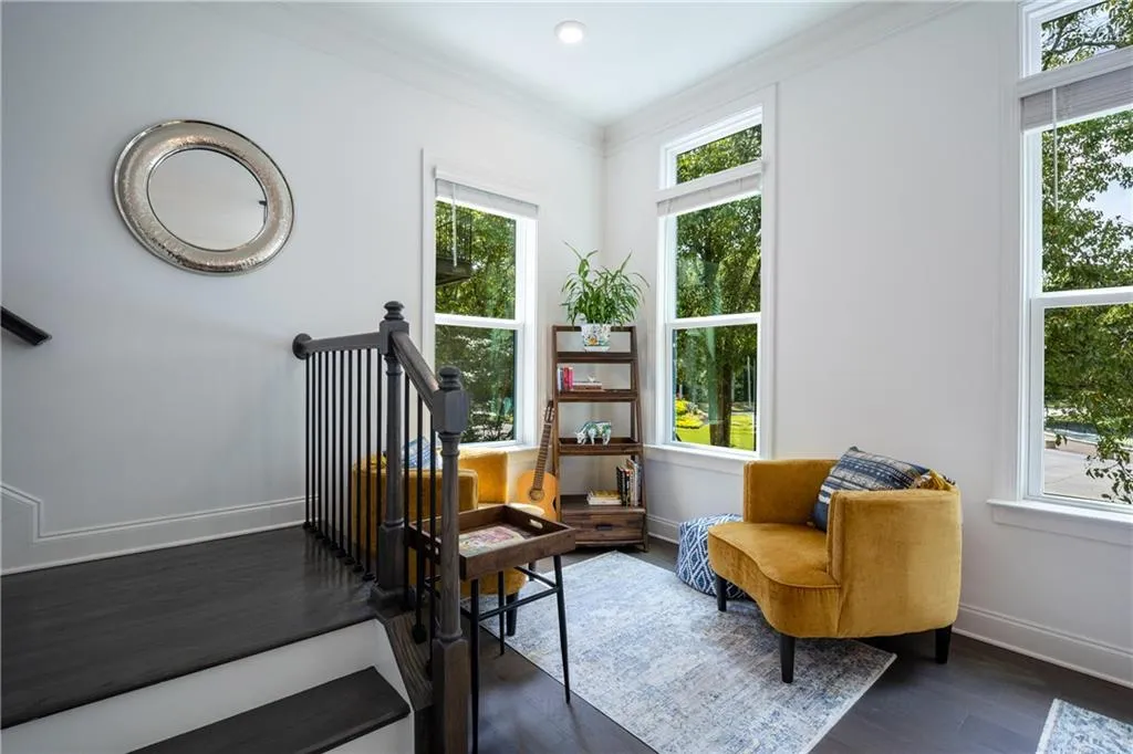 Living area featuring dark wood-type flooring and crown molding