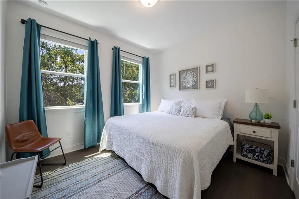 Bedroom featuring dark wood finished floors and baseboards