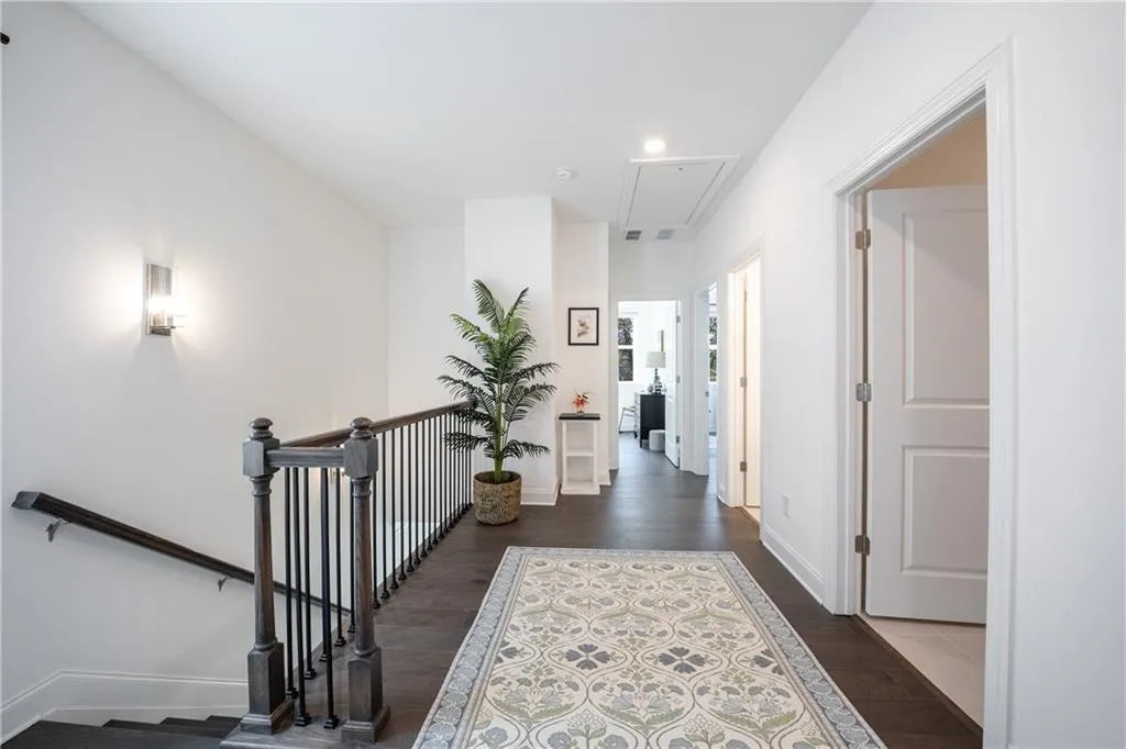 Corridor featuring attic access, an upstairs landing, dark wood-type flooring, and recessed lighting
