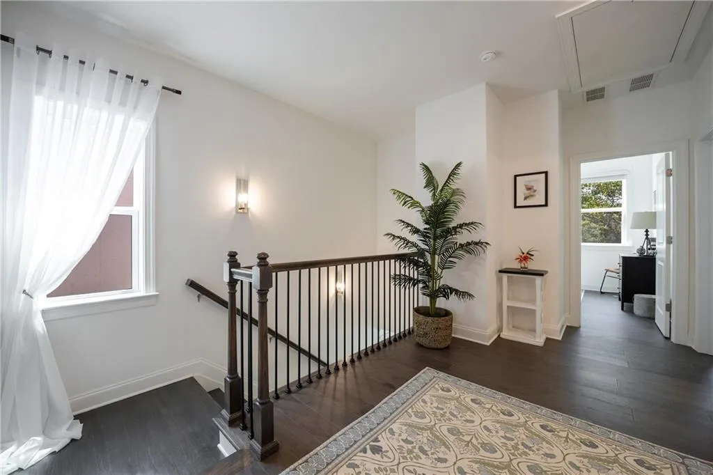 Stairs with wood finished floors and baseboards