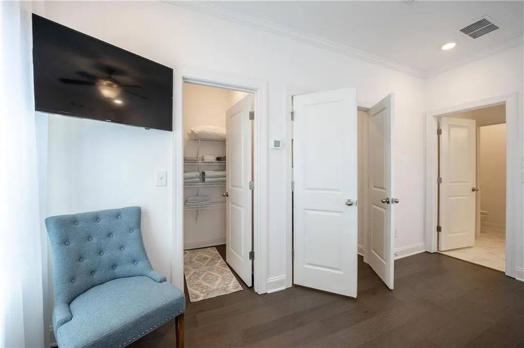 Sitting room featuring ornamental molding, dark wood finished floors, and recessed lighting