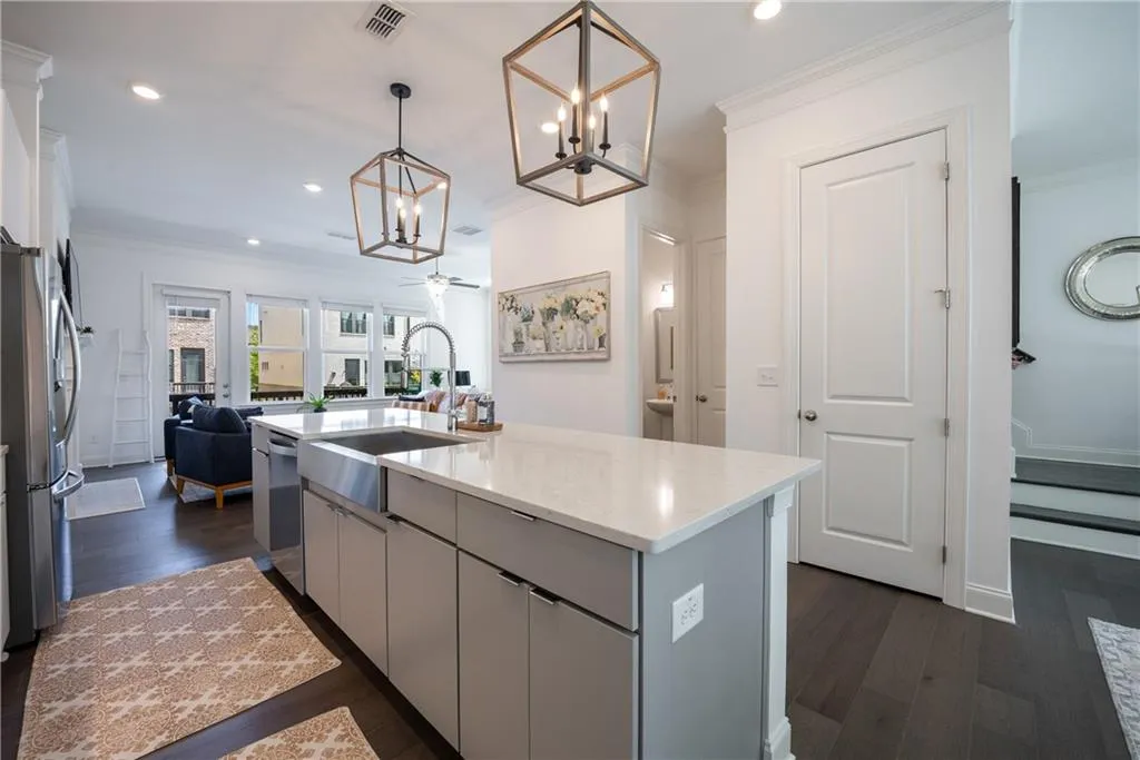 Kitchen with gray cabinetry, recessed lighting, ornamental molding, dark wood-style floors, and appliances with stainless steel finishes