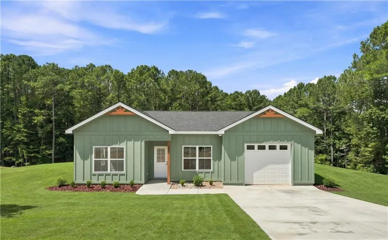 Contemporary exterior with board and batten siding, attached garage, concrete driveway, and covered front entry