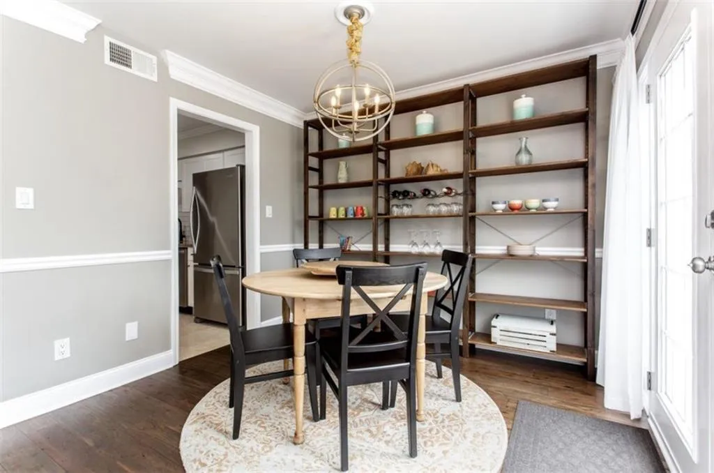 Dining area featuring crown molding, an inviting chandelier, dark hardwood / wood-style flooring, and plenty of natural light