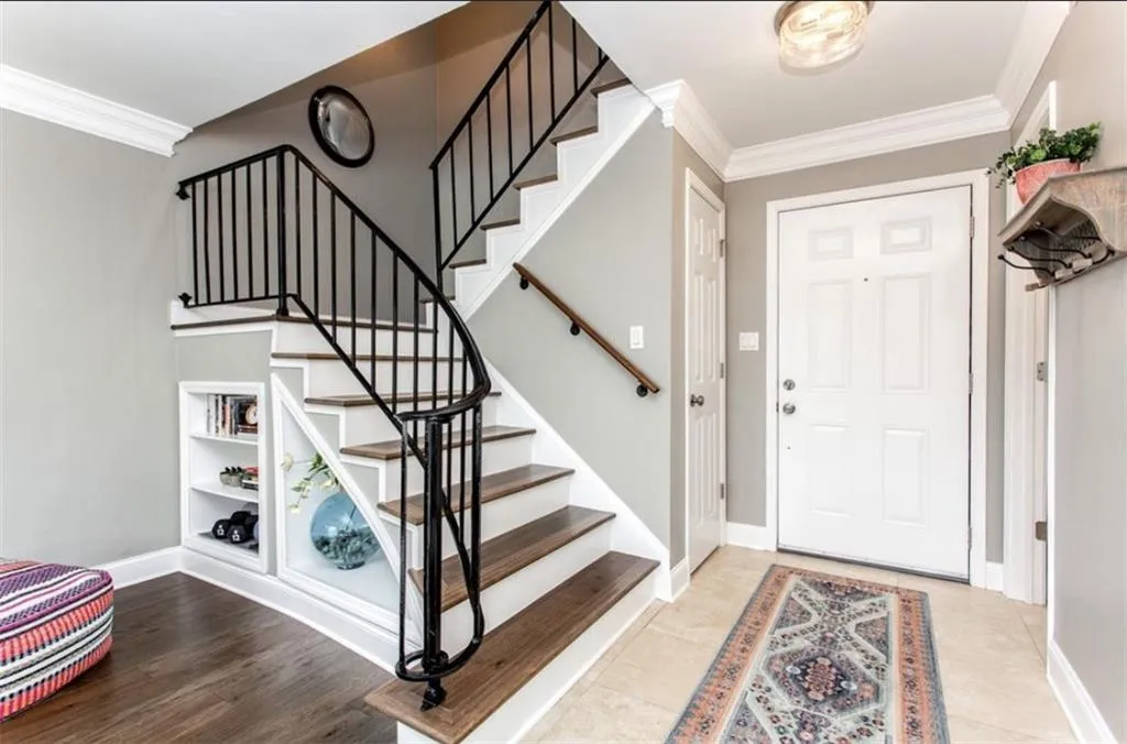 Entrance foyer featuring ornamental molding and light hardwood / wood-style flooring