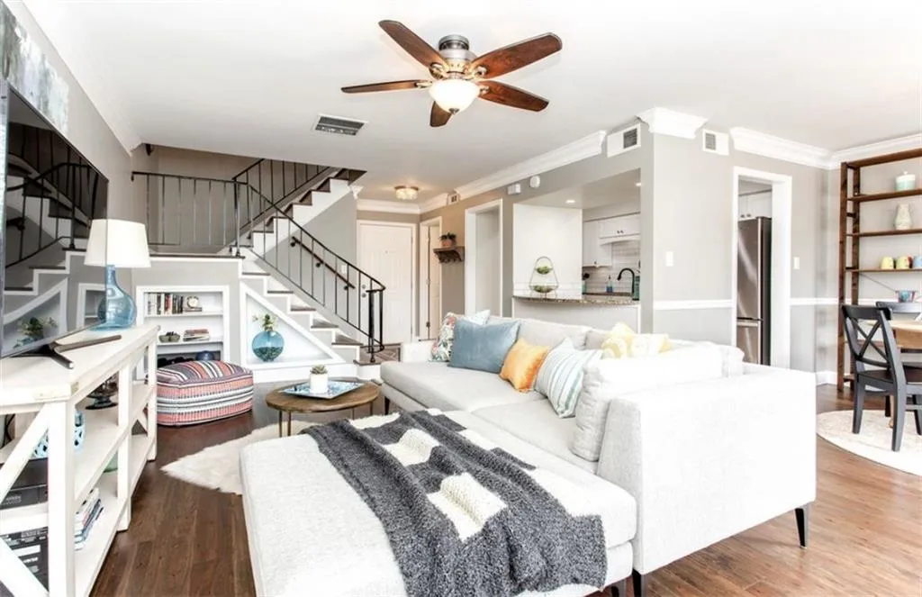 Living room with ornamental molding, ceiling fan, and dark hardwood / wood-style floors