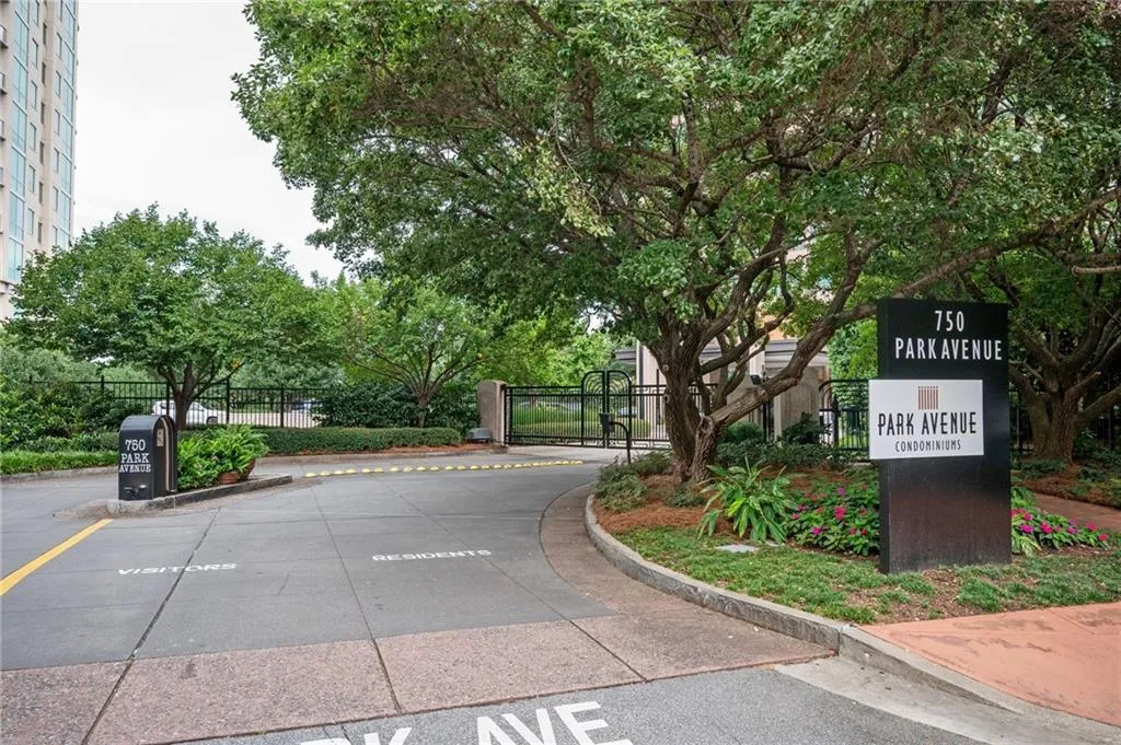 Gated entrance with brick paver driveway leading to 750 Park Avenue