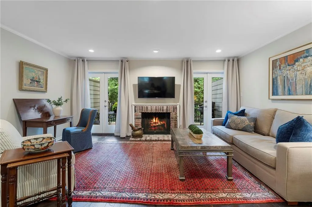 Elegant living room anchored by a wood-burning fireplace with tile surround and built-in shelving