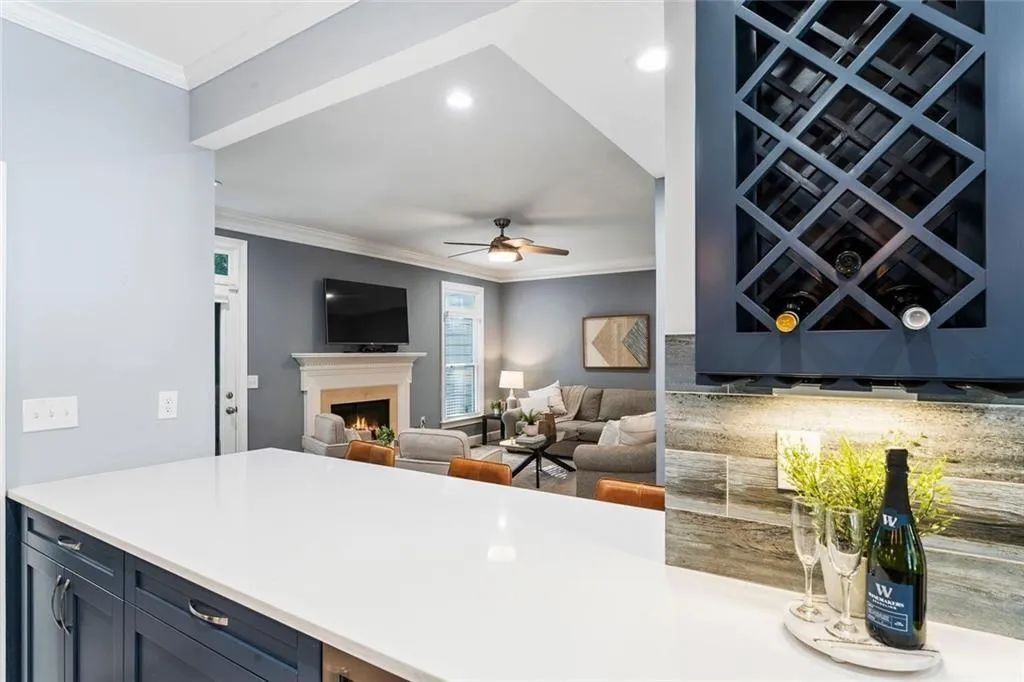 • Bar area with built-in wine rack. • Zephyr beverage cooler underneath quartz counter