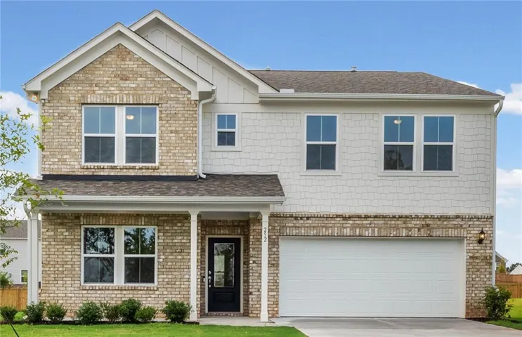 Two-story residence featuring a brick and shingle facade