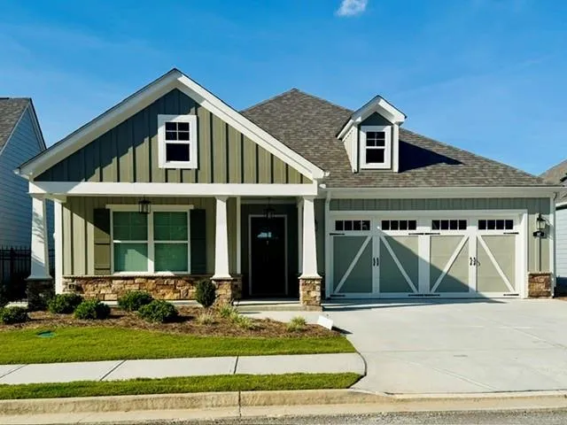 Craftsman-style exterior with board and batten siding and stone accents