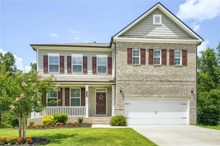 Two-story residence featuring brick and siding exterior construction