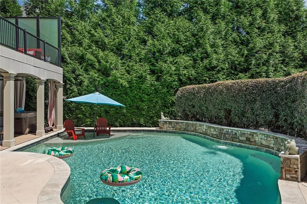 View of swimming pool with pool water feature and a patio View of swimming pool with pool water feature and a patio