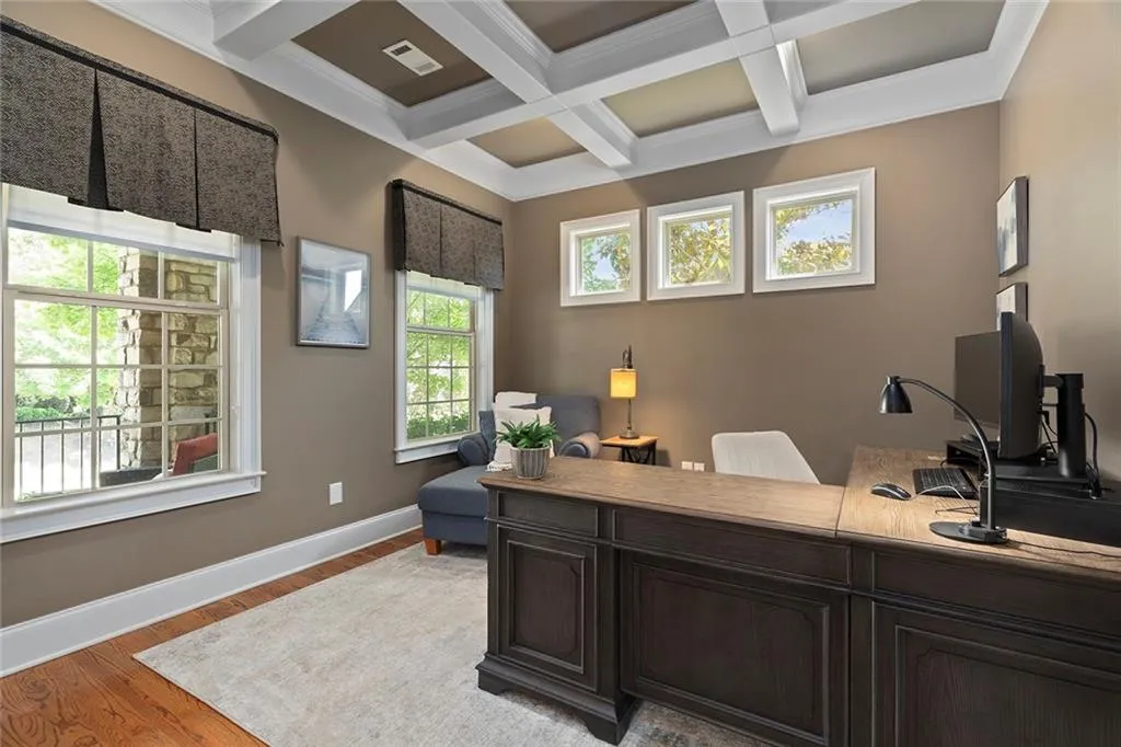 Home office with crown molding, beamed ceiling, hardwood / wood-style floors, and coffered ceiling Home office with crown molding, beamed ceiling, hardwood / wood-style floors, and coffered ceiling