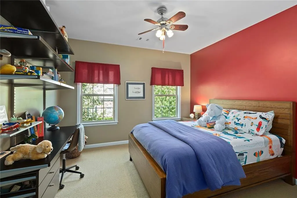 Bedroom featuring ceiling fan and carpet Bedroom featuring ceiling fan and carpet