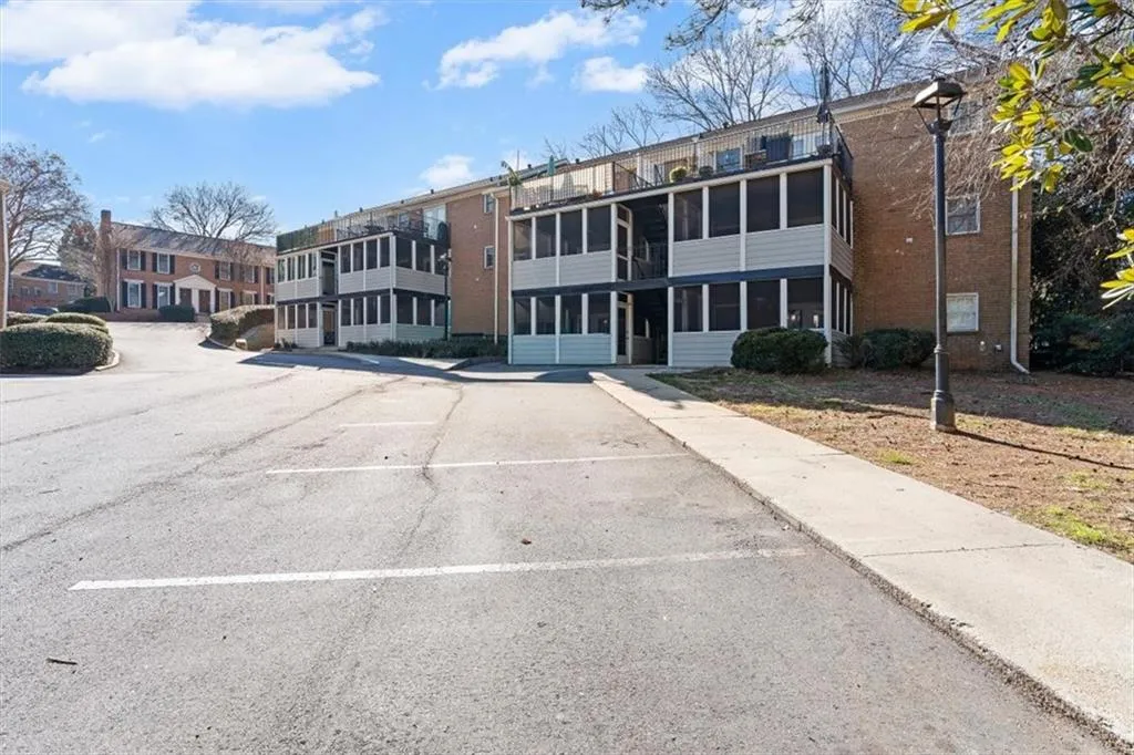 View of apartment building / complex with uncovered parking