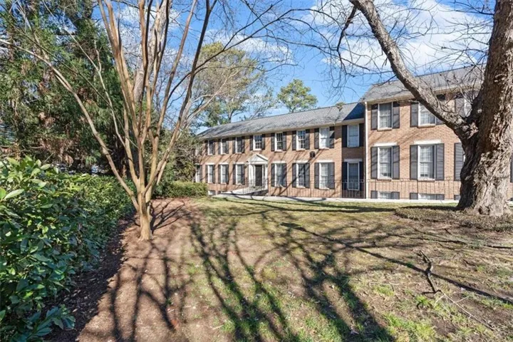 View of front facade with brick siding and a front yard