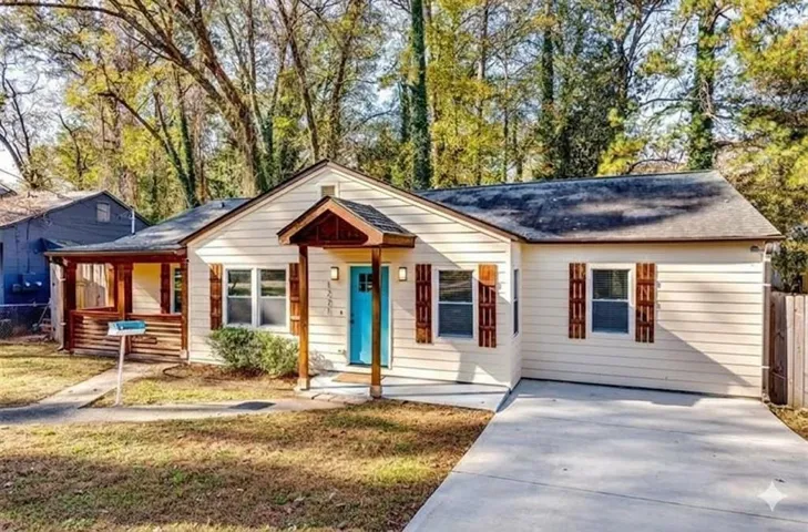 Bungalow with a porch and concrete driveway