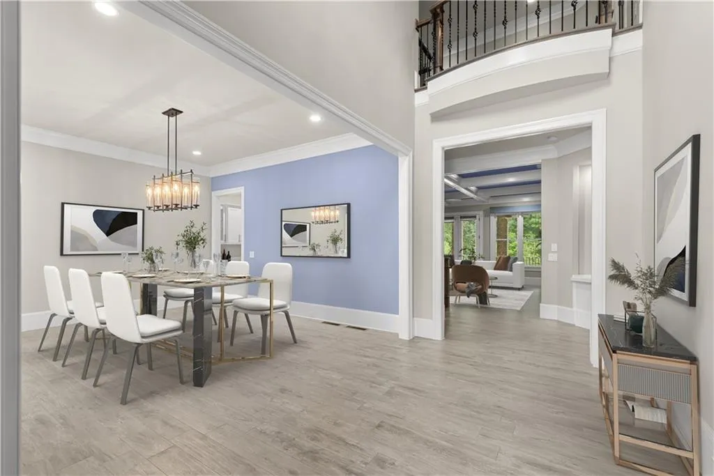 Dining room with light wood-type flooring, ornamental molding, and a chandelier