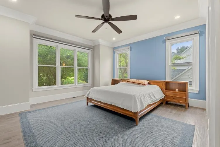 Bedroom featuring crown molding, hardwood / wood-style flooring, and ceiling fan