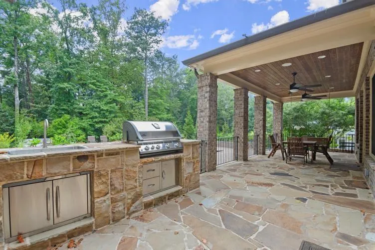 View of patio / terrace featuring ceiling fan, sink, and area for grilling