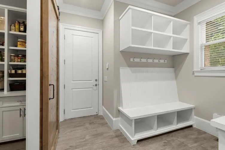 Mudroom featuring crown molding and light hardwood / wood-style flooring