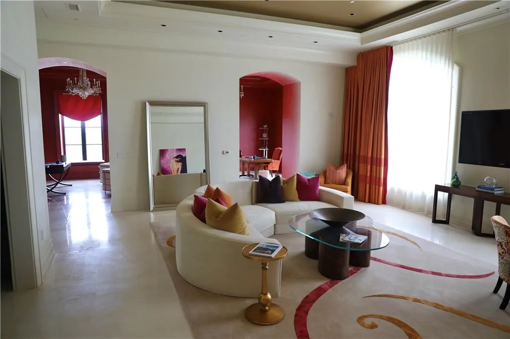 Living room with a raised ceiling and a chandelier
