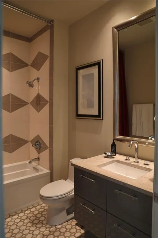 Full bathroom featuring shower / bathtub combination with curtain, vanity, and toilet