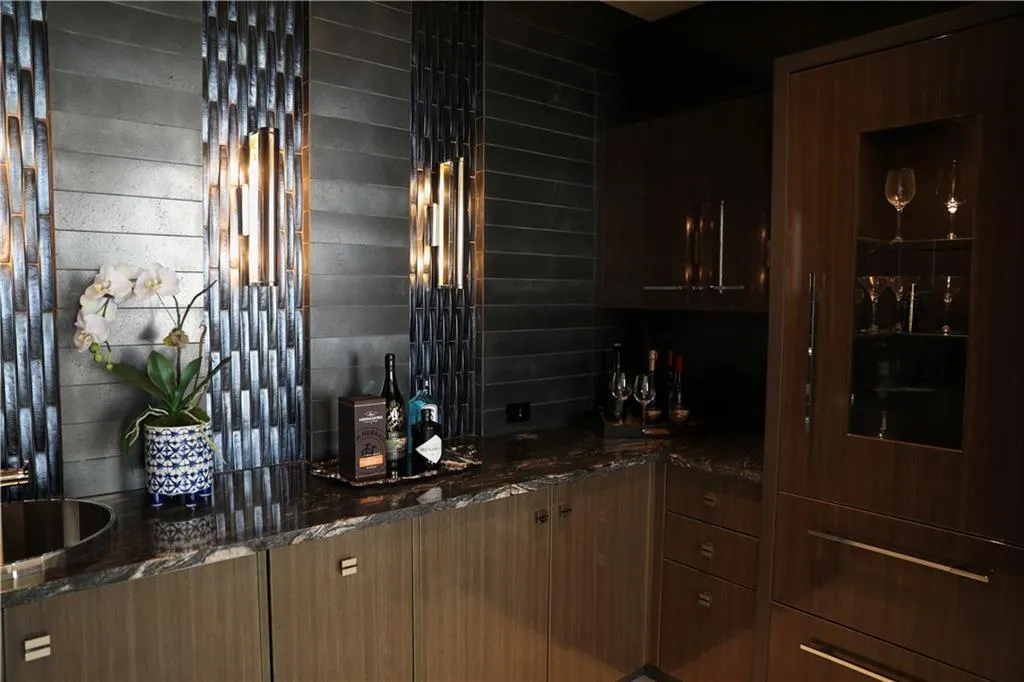 Bar with backsplash and dark stone countertops