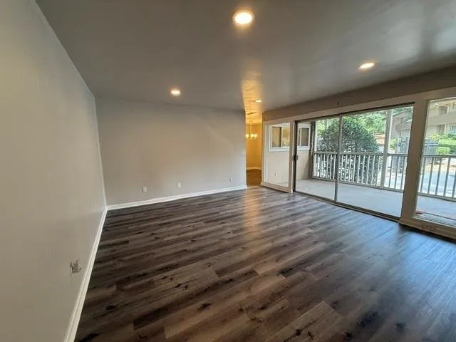 Family room with new flooring and can lights.