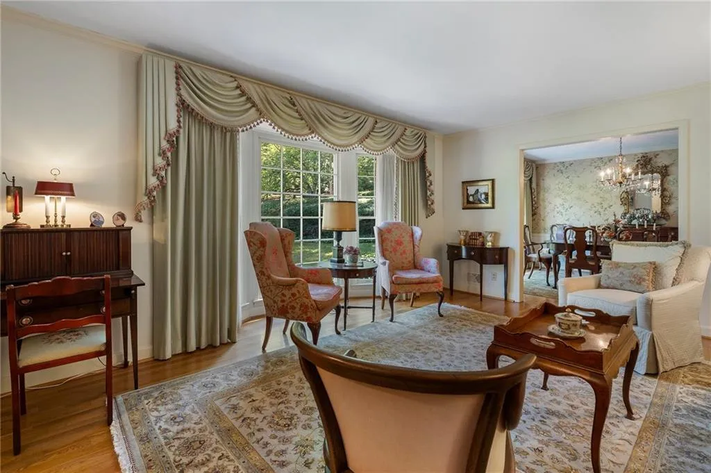Living area featuring a notable chandelier and light wood-type flooring